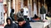 Migrants, mostly from Afghanistan, wrapped in jackets and blankets because of the cold, wait on a platform at the railway station in Rijeka, on the Adriatic coast in western Croatia in February.