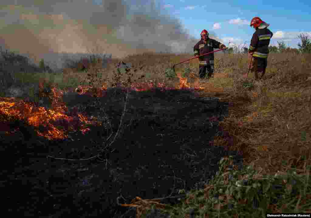 Ukrainian firefighters deal with a grass fire near a frontline position in the Zaporizhzhya Oblast on September 3. Senior Ukrainian military figures have claimed that Russia’s first and strongest line of defense has been breached in this southern region. 