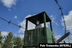 The former watchtower now houses a mannequin who keeps tabs along the barbed-wire fence.