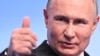 Russian President Vladimir Putin meets with the media at his campaign headquarters in Moscow on March 18.
