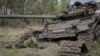 The body of a Russian soldier is seen near a destroyed Russian tank in the newly liberated village of Storozheve in Ukraine's Donetsk region on June 14.