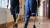 Ukrainian soldiers with prosthetic legs walk with crutches at a rehabilitation center near Lviv in western Ukraine.