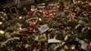 Flowers are seen placed around portraits of late Russian opposition leader Aleksei Navalny at a makeshift memorial in front of the Russian Embassy in Berlin on February 23 during a rally marking the eve of the second anniversary of Russia's invasion of Ukraine. 