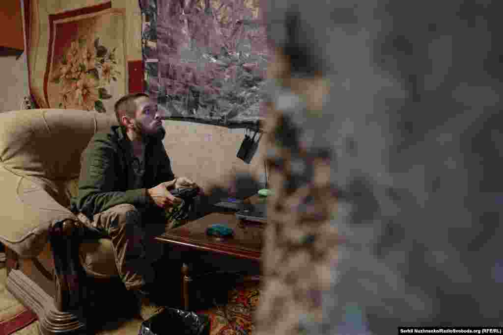 A Ukrainian soldier monitors Russian positions while piloting a drone from inside a building in Vuhledar. The town lies near a strategically crucial highway and railway line.&nbsp;
