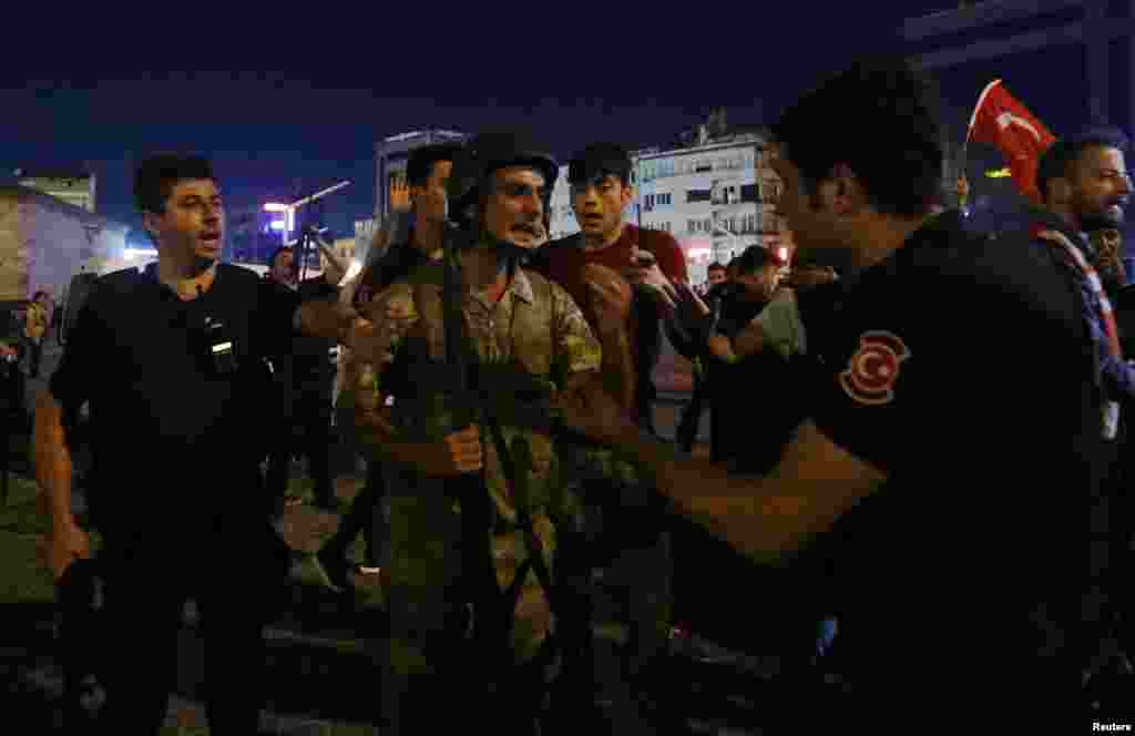 Turkish soldiers surrender their weapons to police on Taksim Square. A statement released by the military said the coup attempt was a response to "rising autocratic rule... and increased terrorism."