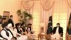 Pakistani Prime Minister Imran Khan (right) talks with Taliban co-founder Mullah Abdul Ghani Baradar (fifth from left) during a meeting along with his delegation in Islamabad on December 18.