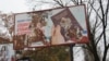 A ripped billboard promotes Russian passports in the Kherson city center.