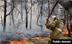 A firefighter works to prevent fire from spreading in Qostanai on September 4.