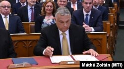 Hungarian Prime Minister Viktor Orbán signs the documents in parliament in Budapest declaring him prime minister for the fourth consecutive time on May 16.