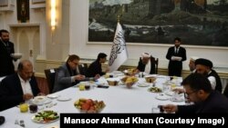 Pakistani national-security adviser Moeed Yusuf speaks to the Taliban's acting deputy prime minister, Abdul Salam Hanafi, (center) in Kabul on January 29. 