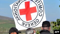 Armenia -- Servicemen escort Eldar Tagiyev, an Azerbaijani hostage, (C) during his return to Azerbaijan on the Ijevan-Qazax highway near the village of Kayan, 04Nov2010