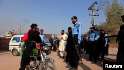Police block the road leading to the house of Pakistani opposition leader Imran Khan in Islamabad, Pakistan, on October 28.