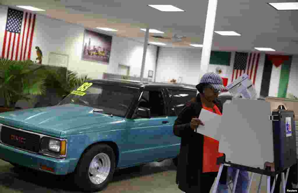 A voter looks over her ballot at Sam's Auto Sales in Chicago, Illinois.