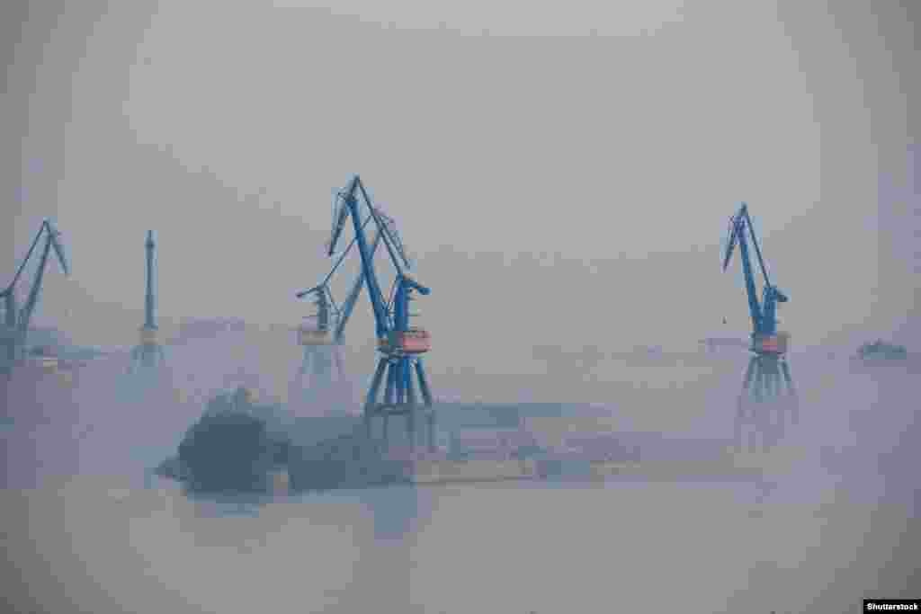 Port cranes at Tulcea, near where the Sulina Canal meets the Danube River The limited capabilities of Romanian ports has resulted in a huge buildup of both ships, trucks, and trains, which queue on Ukraine's borders to export grain. Ukraine's railway lines are wider than most of the rest of Europe, resulting in sluggish transport speeds from the country's western border. 
