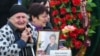Relatives of the Kerch school-attack victims grieve at a ceremony to pay their last respects in the city center on October 19.