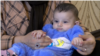 Tajikistan - Afghan family who fled to Tajikistan just before their daughter Mohanna was born - screen grab