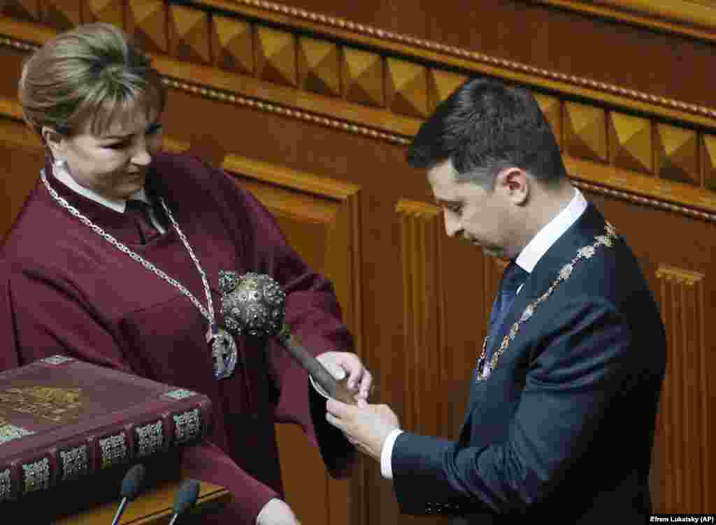 Zelenskiy receives the Ukrainian symbols of power.