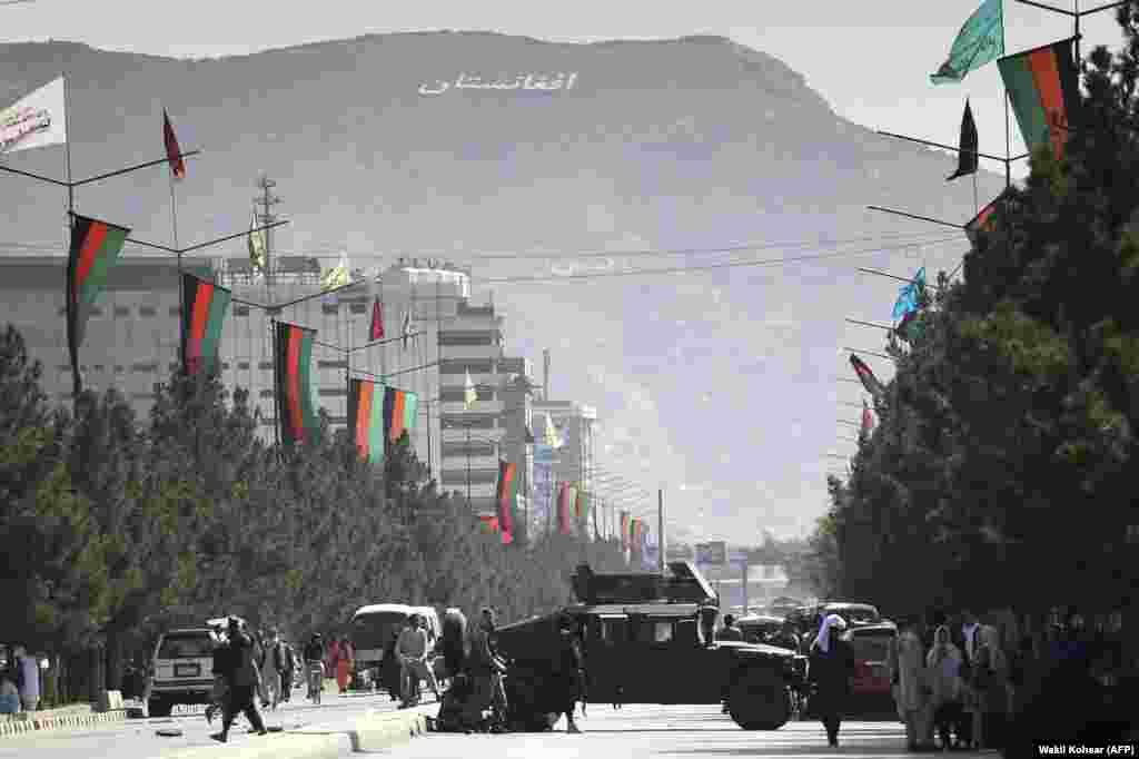 Taliban fighters block a road in central Kabul with a U.S.-made Humvee on August 28. 