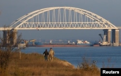 A Russian cargo ship is seen beneath the Kerch Bridge connecting the Russian mainland with the Crimean Peninsula on November 25.