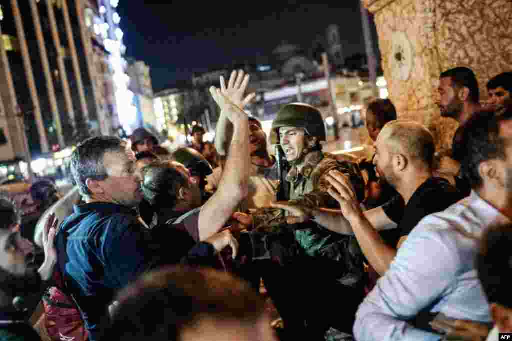 In Istanbul, things became increasingly tense as civilians swarmed soldiers who had taken up posts on Taksim Square. 