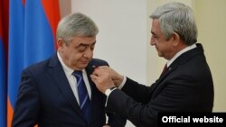 Armenia -- President Serzh Sarkisian (R) awards a medal to his brother Levon Sarkisian, 22 March, 2016.