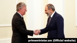 Acting Armenian Prime Minister Nikol Pashinian (right) meets U.S. national-security adviser John Bolton in Yerevan on October 25.