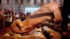 People surround a statue of Soviet state founder Vladimir Lenin that was toppled by protesters during a rally organized by supporters of EU integration in Kyiv on December 8, possibly setting off the rash of Lenin-idolatry abuse.