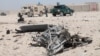 Afghan security forces inspect the scene of a suicide bombing at a police station in Lashkar Gah, the provincial capital of restive Helmand Province, on October 10.