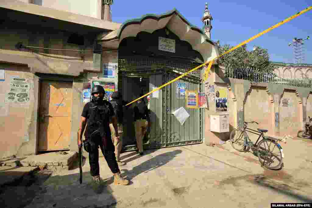 A security official at the entrance to the madrasah.