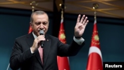 Turkish President Tayyip Erdogan addresses the nation in a live television broadcast from the presidential palace in Ankara, Turkey on July 21.
