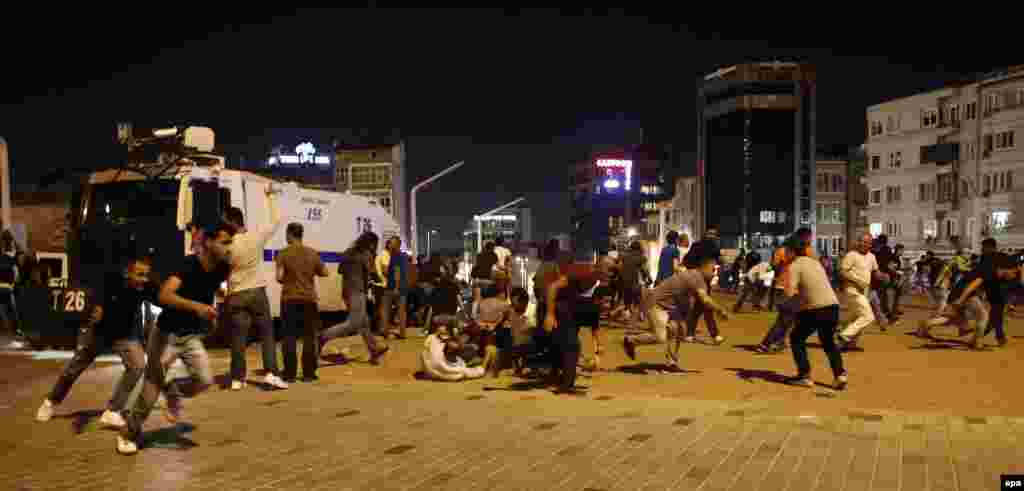 People run and hide as Turkish Army jets fly above Taksim Square in Istanbul. A senior Turkish official has vowed that any aircraft in the hands of coup plotters "will be shot down." 