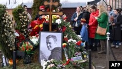 People pay tribute at the grave of late Russian opposition leader Aleksei Navalny on the day of Russia's presidential election in Moscow on March 17.