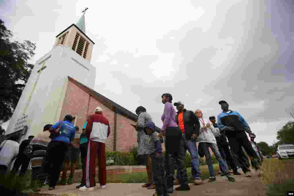 People wait in line outside a polling location in Mobile, Alabama.