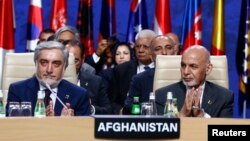 Afghanistan's President Ashraf Ghani (R) and Afghanistan's Chief Executive Abdullah Abdullah applaud during a session at the NATO Summit in Warsaw, Poland on July 9. 
