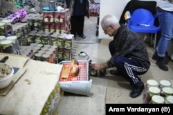A man toasts bread on a heater in a store in Stepanakert.