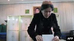 A woman casts her ballot at a polling station in Ashgabat.