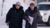 Lyudmila Navalnaya, mother of the late Russian opposition leader Aleksei Navalny, and lawyer Vasily Dubkov arrive at the regional department of Russia's Investigative Committee in the town of Salekhard, Russia, on February 17.