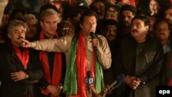FILE: Imran Khan (C) head of opposition political party Pakitan Tehrik-e-Insaf speaks to supporters during a protest against the ruling party Pakistan Muslim League Nawaz in Lahore.