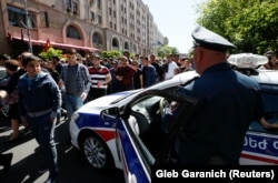 A policeman stands guard as supporters of Armenian opposition leader Nikol Pashinian stage a rally in Yerevan on April 25.