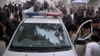 Officers examine a damaged police vehicle after a recent attack (file photo)