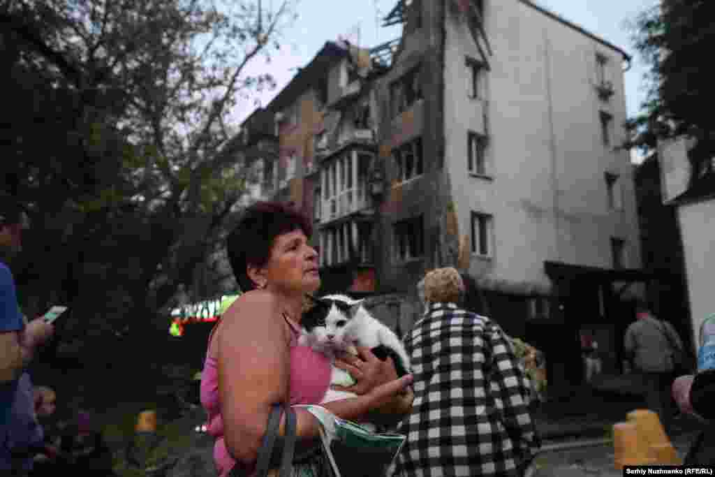 Residents outside one of several buildings in Kyiv hit by Russian air strikes overnight.