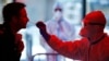 A medical employee collects a smear at a special coronavirus test center in Cologne, Germany.