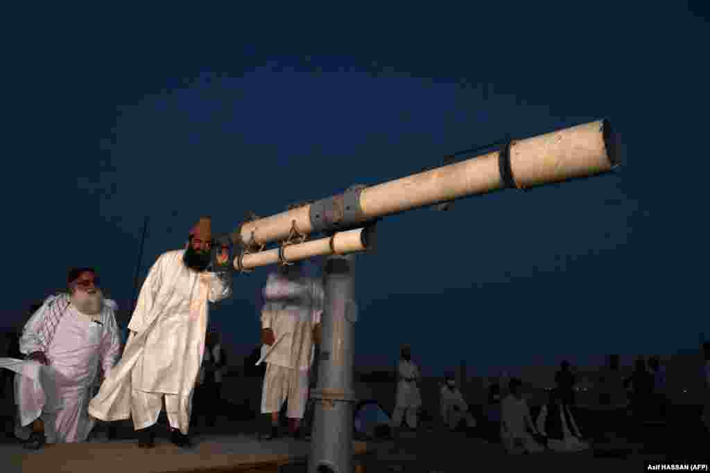 Maulana Abdul Khabeer Azad, a member of Pakistan's Ramadan moon-sighting committee, looks through a telescope for the new moon that signals the start of the Muslim fasting month of Ramadan in Karachi on April 23.