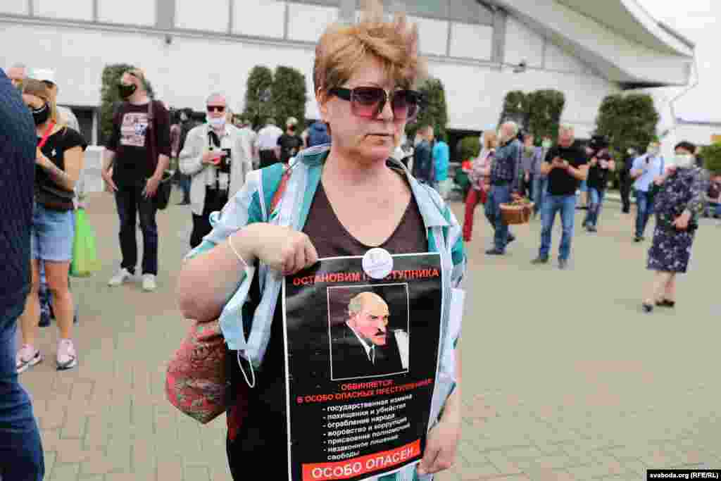 A protester at the June 7 rally in Minsk holds a portrait of Belarusian President Alyaksandr Lukashenka with a sign reading: &quot;Stop the criminal man.&quot; &nbsp;