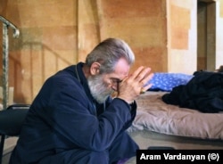 Archbishop Pargev Martirosian, the current primate of the Artsakh Diocese of the Armenian Apostolic Church, prays as artillery fire is heard landing in Stepanakert.