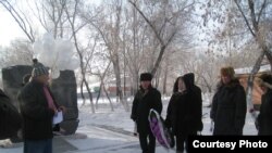 Activists lay flowers in memory of victims of the Zhanaozen unrest in the Kazakh city of Karaganda.