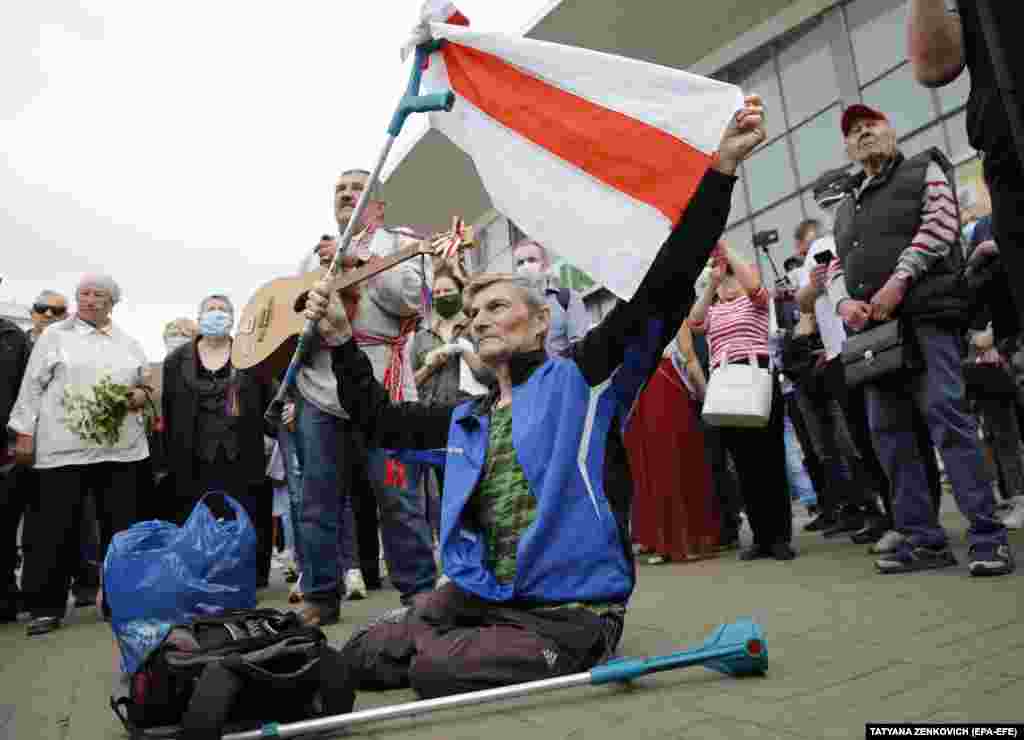 A rally attendee holds a white-red-white flag, which is&nbsp;used by opposition supporters, during the June 7 rally. &nbsp;