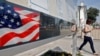 A woman walks by a board with consular information outside the U.S. Embassy in Moscow on August 22.