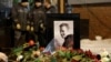 People lay flowers at the grave of Russian opposition politician Aleksei Navalny following his funeral at the Borisovskoye cemetery in Moscow on March 1.