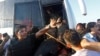 A policeman protects soldiers from the mob after troops involved in the coup surrendered on the Bosphorus Bridge in Istanbul, Turkey on July 16. 